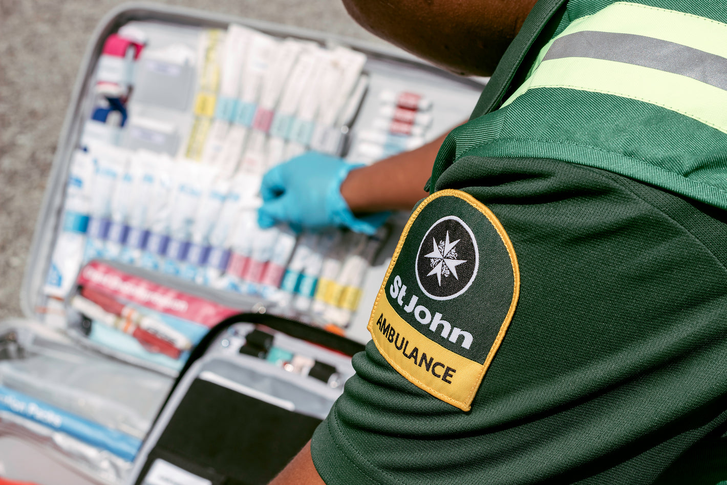 an ambulance officer with an opened first aid kit